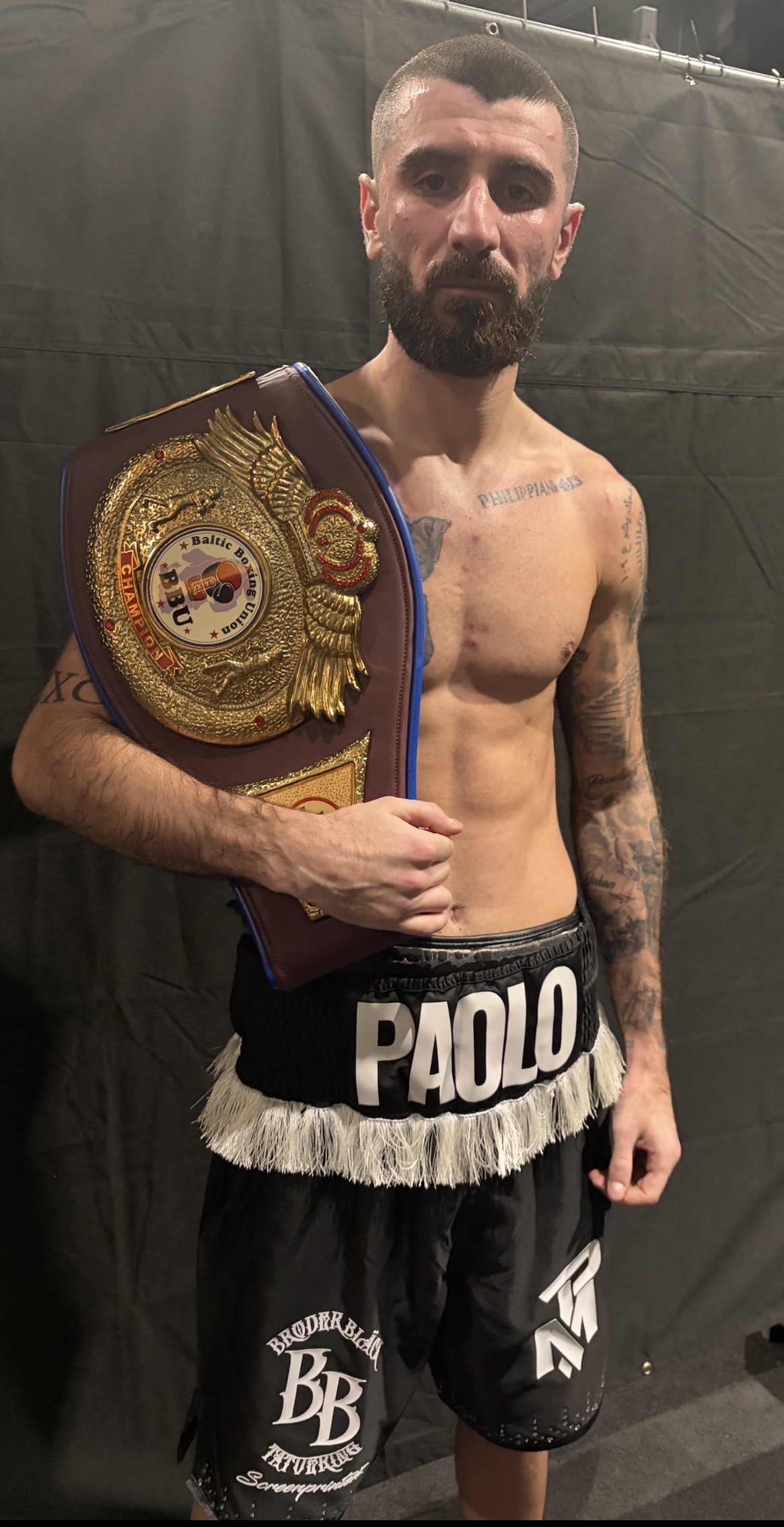 Paolo Magui holds the BBU title belt after a hard-fought 10-round battle against David Rajuili.